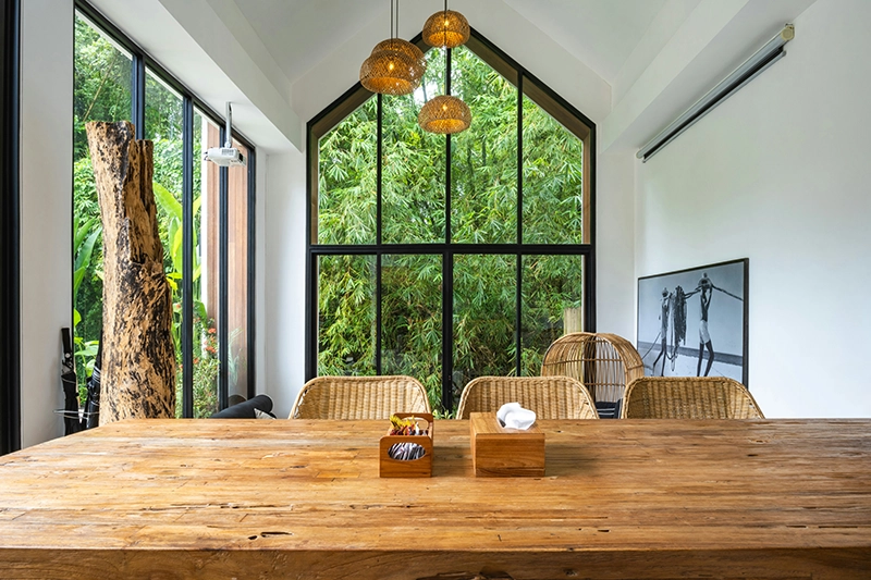 A bright workroom with a long wooden table
